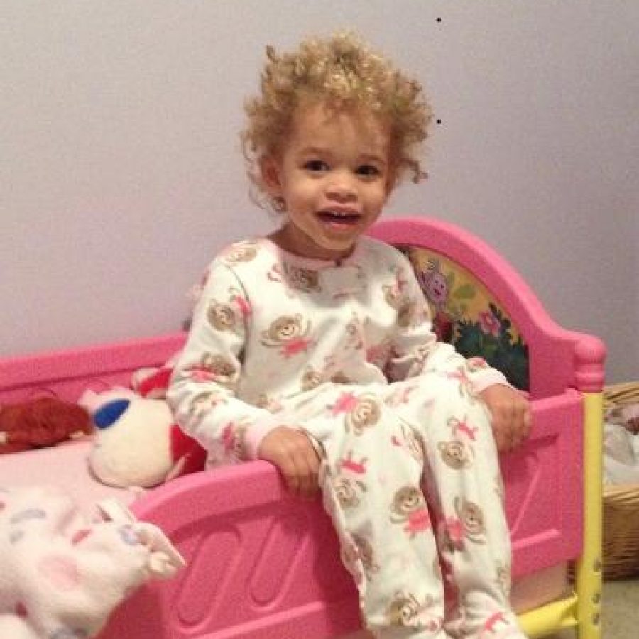 Young Girl Sitting In A Pink Kids Bed